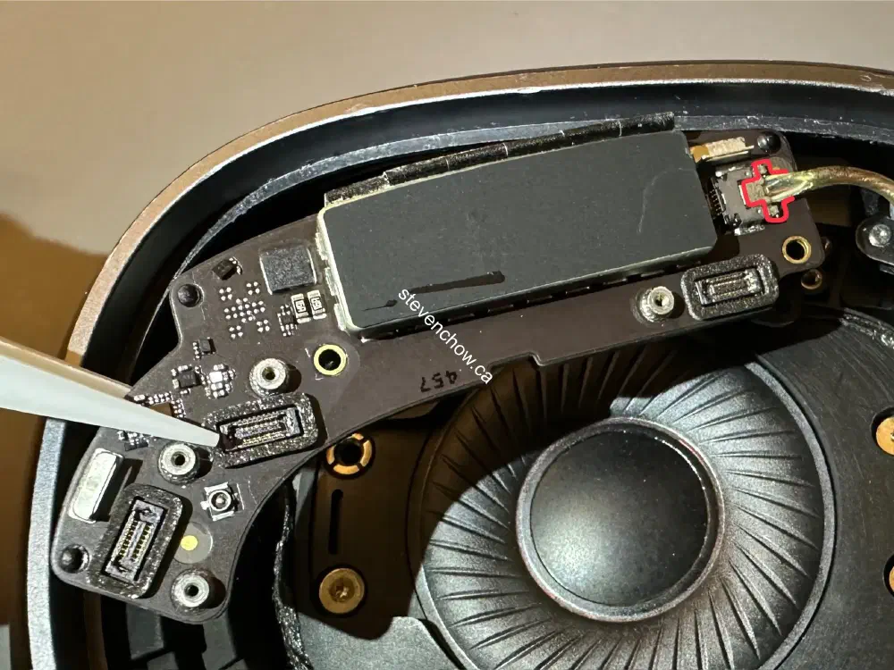 Step 9: Lift board up for easier access to headband connector cable. Pull gently while wiggling to disconnect the cable.